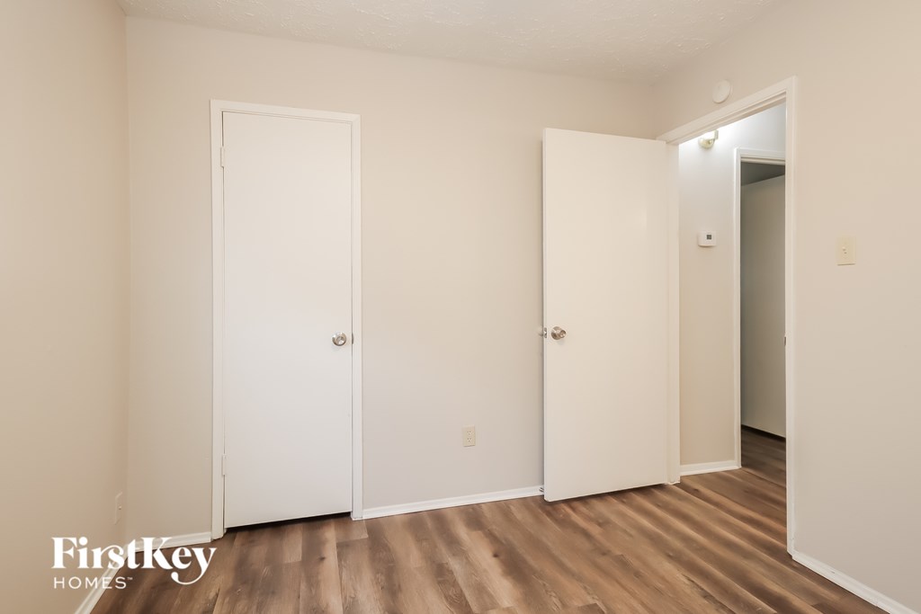 A room with two doors and a wooden floor.