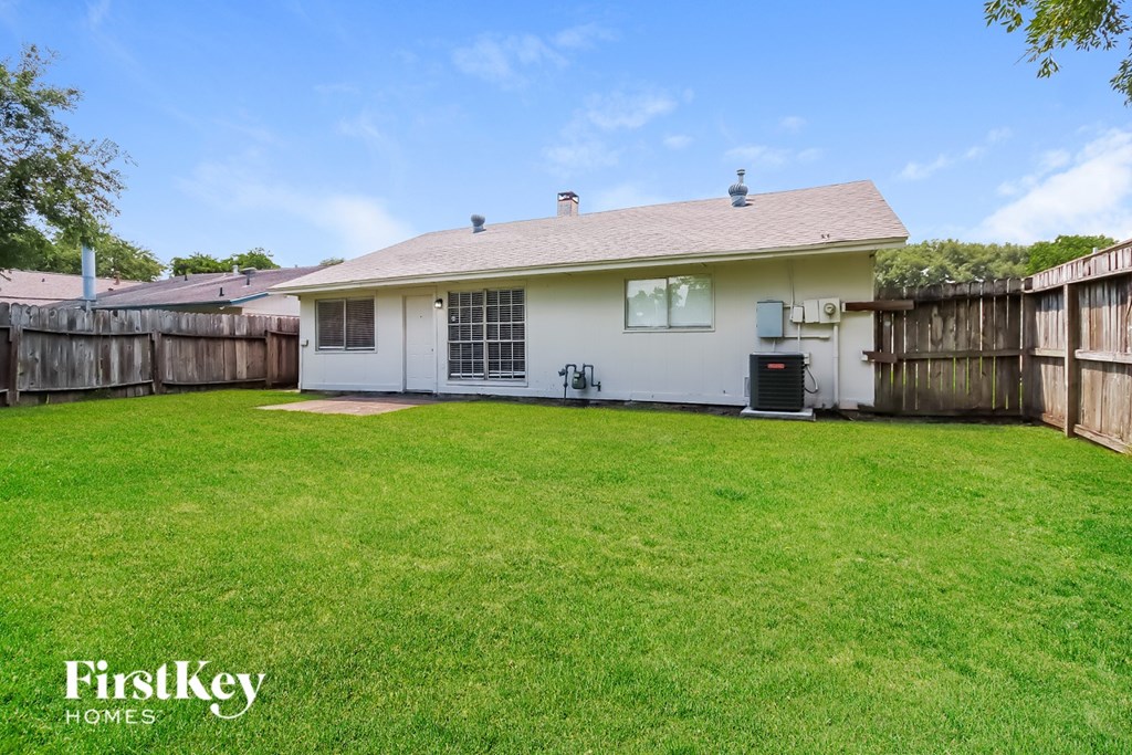 A house with a lawn in front of it.