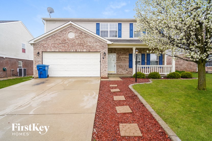 a home with a white garage door in front of it