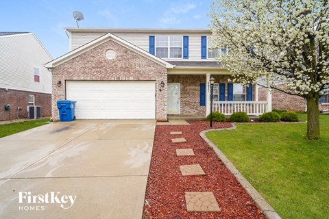 a home with a white garage door in front of it
