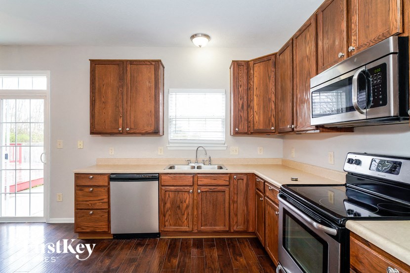 a kitchen with wooden cabinets