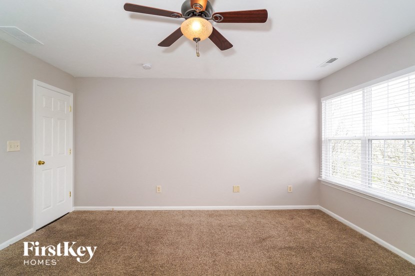 a living room with a ceiling fan and a window