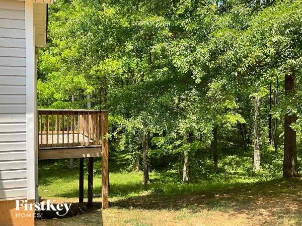 a wooden deck on the side of a house
