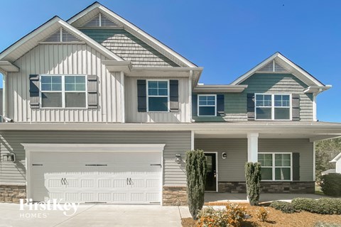 A modern two-story house with a garage.