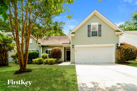 a house with a white garage door and a lawn