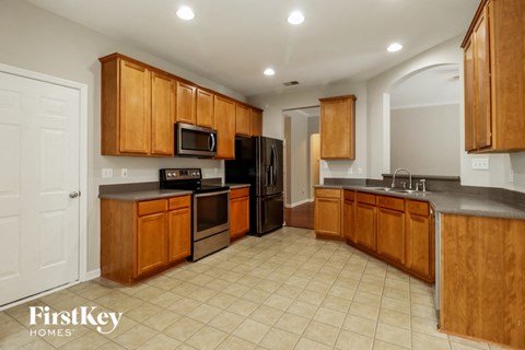a kitchen with wooden cabinets and black appliances