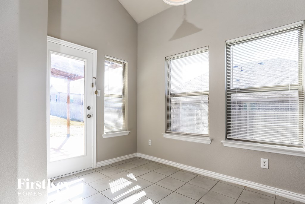 A sunny day in a room with a sliding glass door.