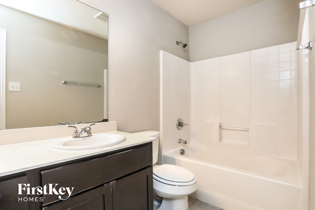 A bathroom with a white toilet and a white sink.