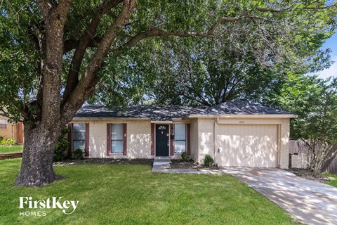 A house with a tree in front of it.