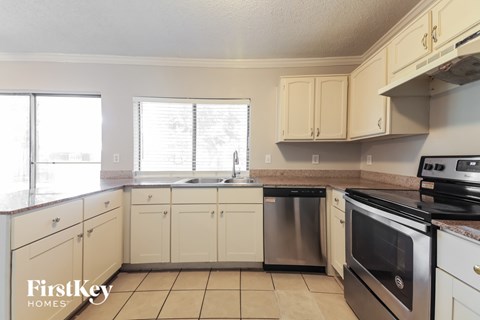 A kitchen with a stove top oven and a dishwasher.