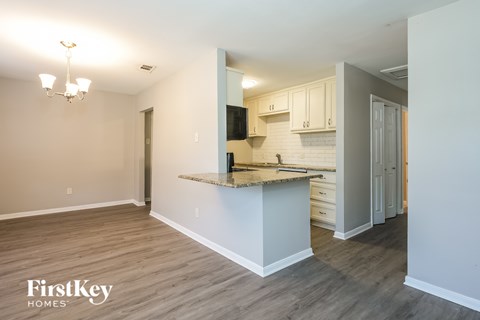 A kitchen area with a counter and cabinets.
