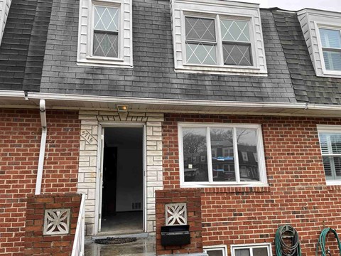 a brick house with a front door and windows