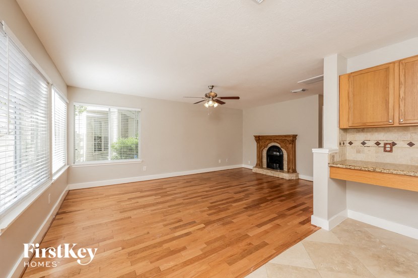 a living room with a fireplace and a wooden floor