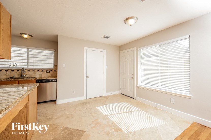 an empty kitchen and living room with a large window