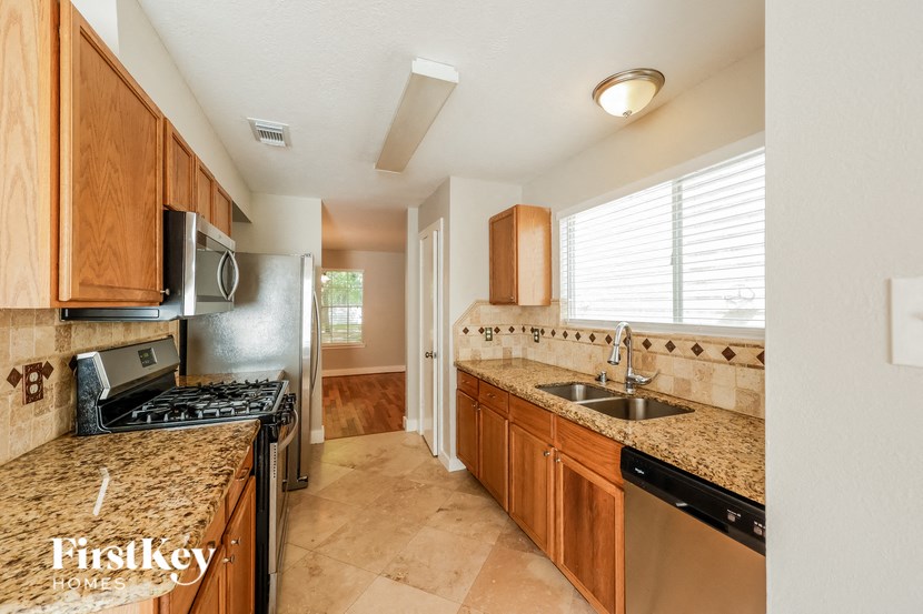 a kitchen with granite counter tops and a sink