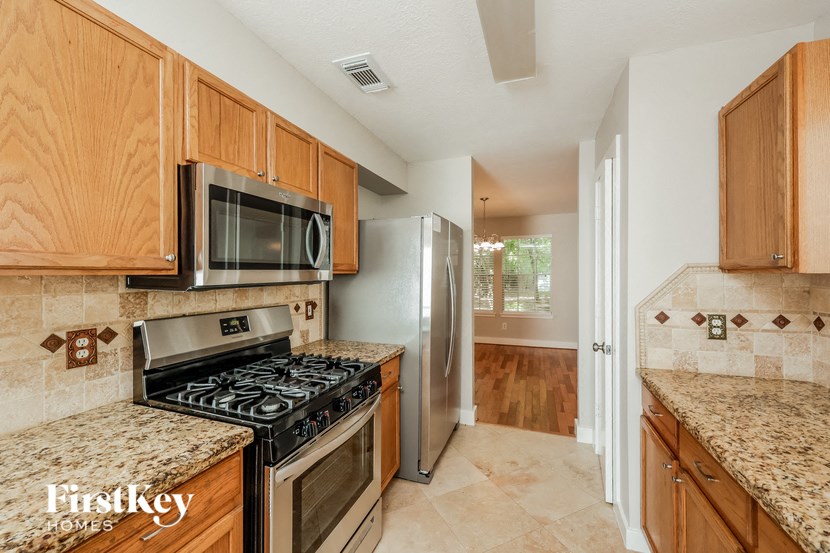a kitchen with stainless steel appliances and granite counter tops
