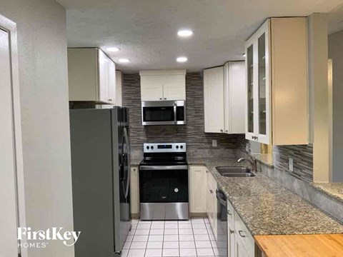 a kitchen with a stove and a refrigerator and a sink