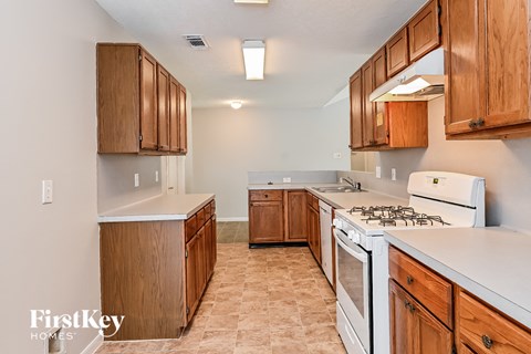 a kitchen with white appliances and wooden cabinets