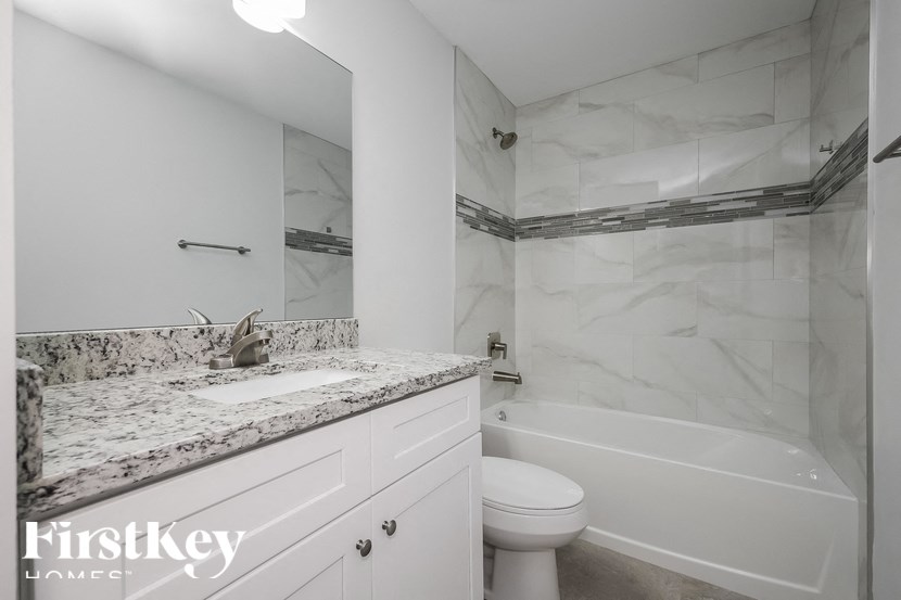 a bathroom with a sink and a toilet and a tub