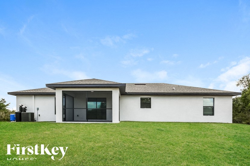 a white house with a grassy yard