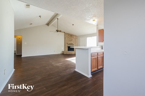 the living room and kitchen of an empty house
