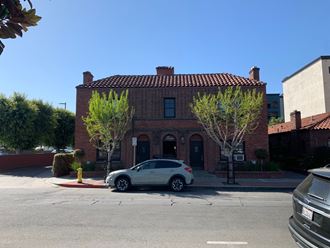 a car parked in front of a brick building