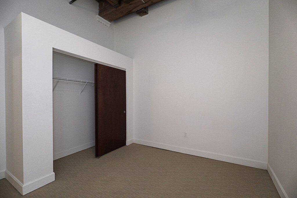 an empty room with a closet and a wardrobe