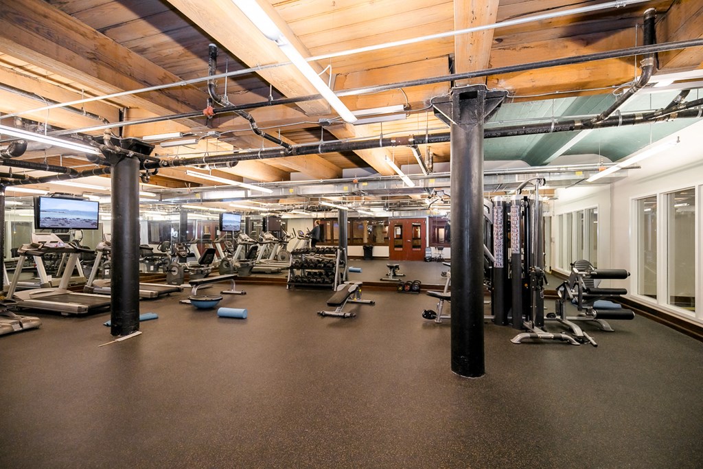 a workout room with weights and other exercise equipment