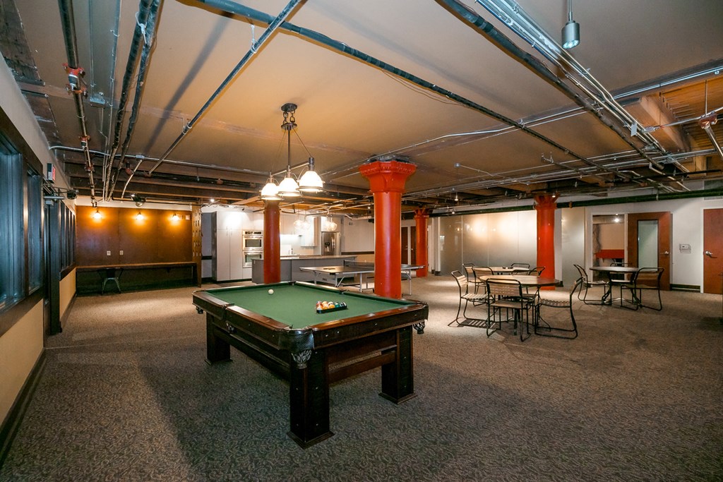 a room with a pool table in the middle of it