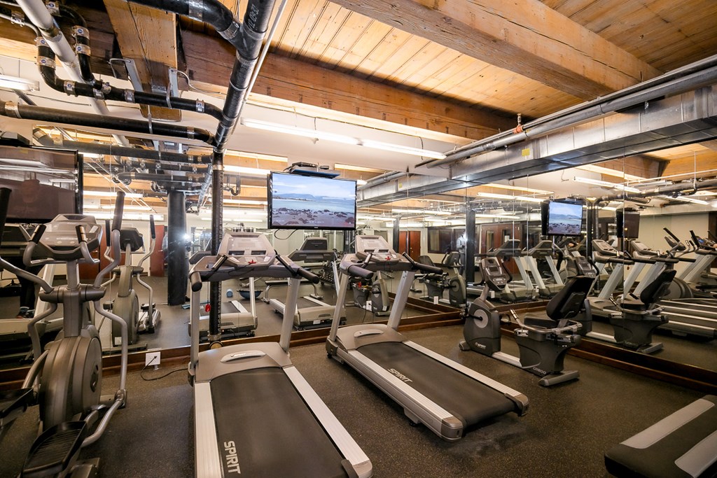 a gym with treadmills and other exercise equipment