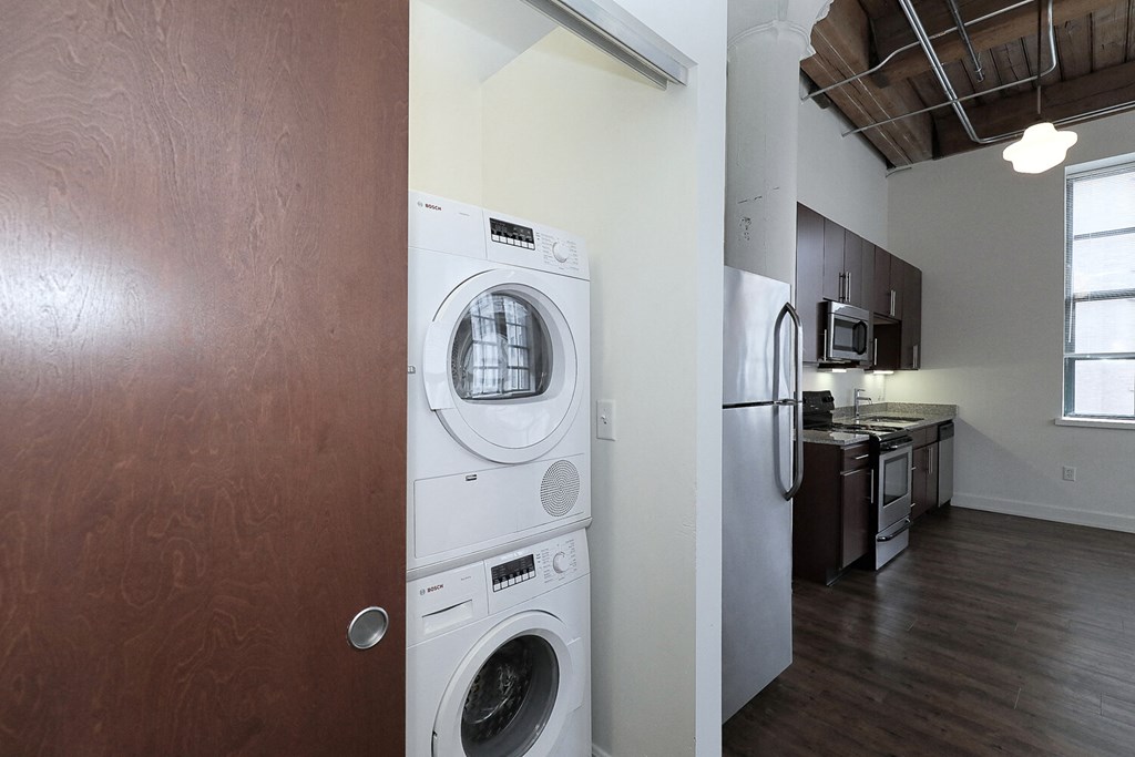 a washer and dryer in a living room with a kitchen