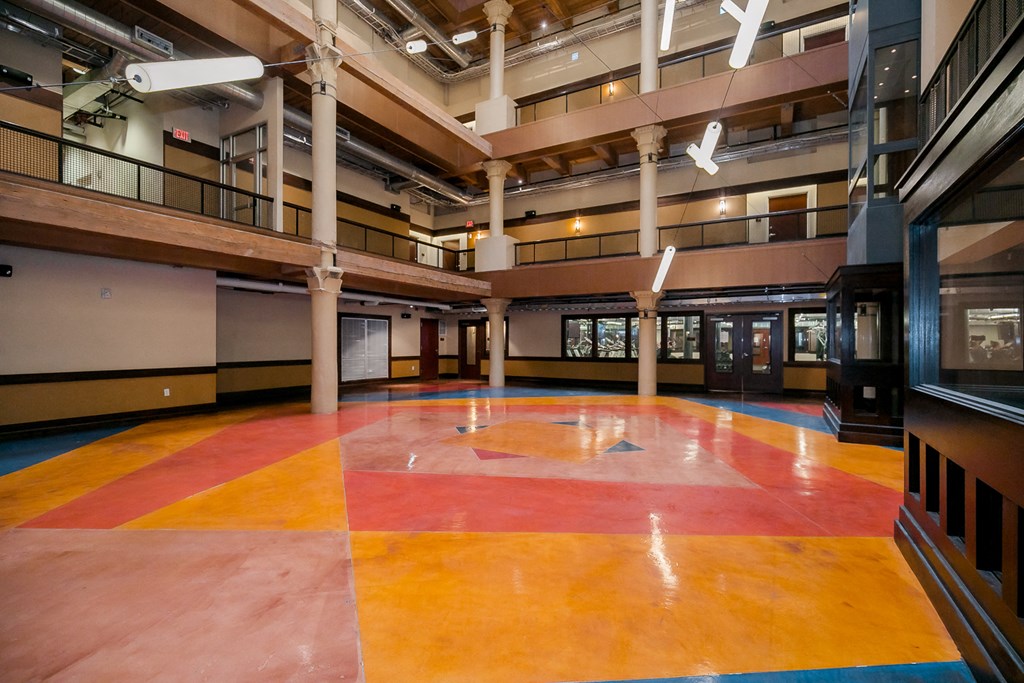 a large empty room with a large rug in the middle of it