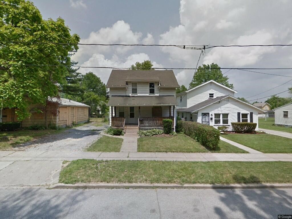 a house on the corner of a street