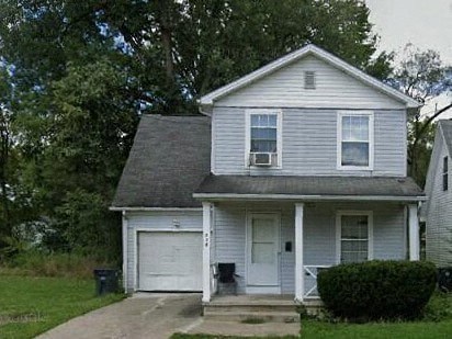 a white house with a gray roof and a driveway