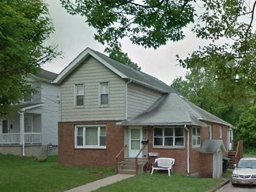 a house with a lawn chair in front of it