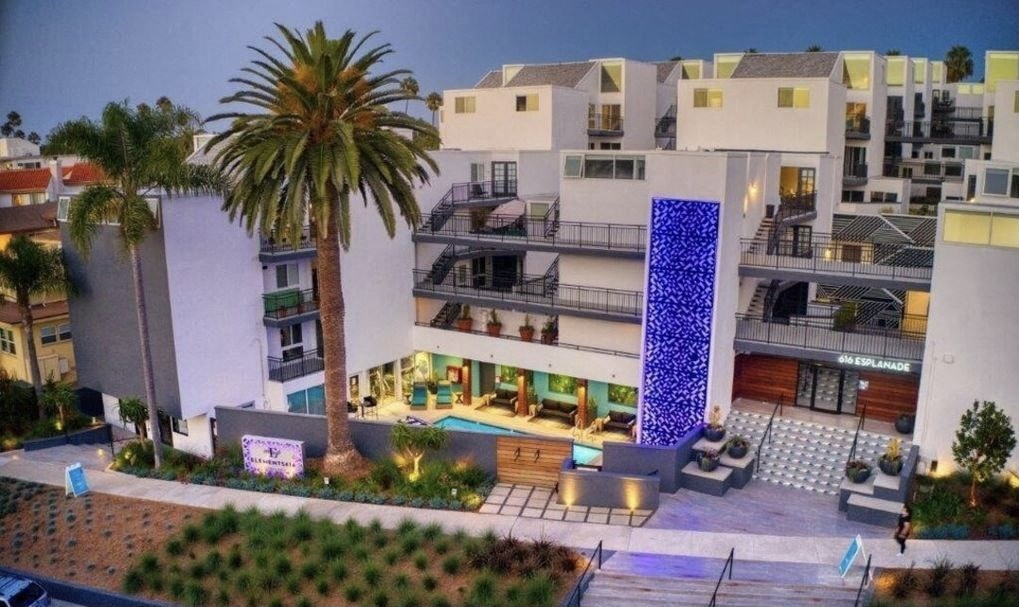 a model of a hotel with a pool and palm trees