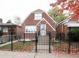 a house with a wrought iron fence in front of it