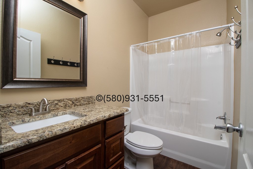 A bathroom with a sink, toilet, and bathtub.