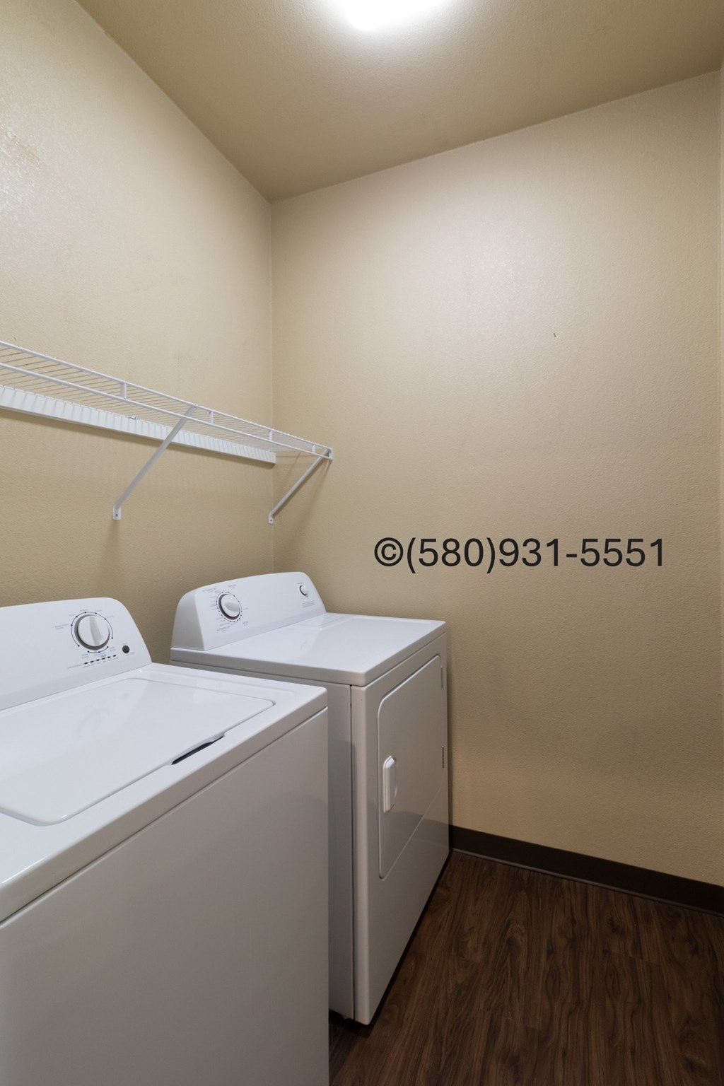 A small laundry room with a washer and dryer.