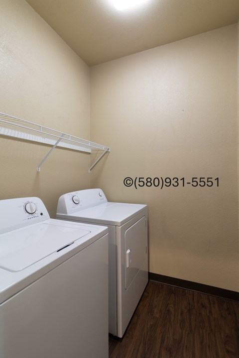 A small laundry room with a washer and dryer.