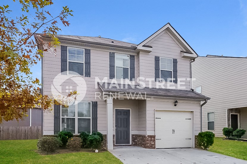 a home with a white house and a white garage door