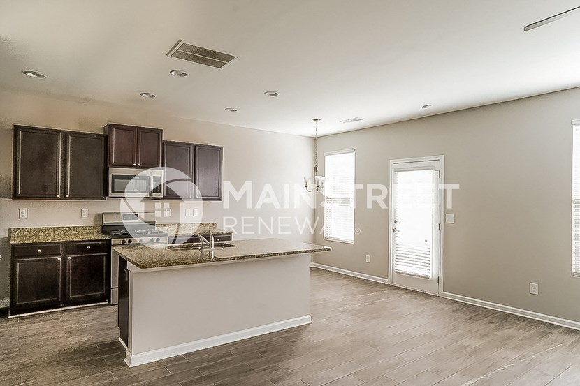 a modern kitchen with a large island in the middle of the room