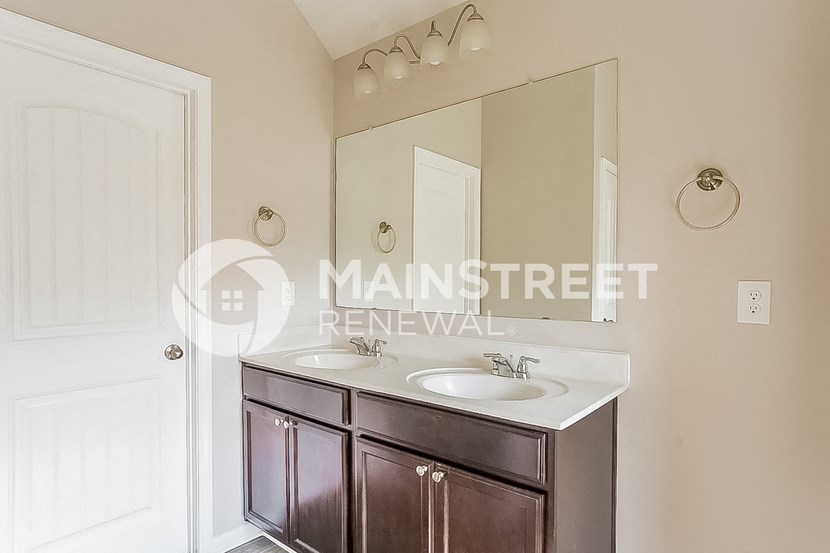 a bathroom with two sinks and a large mirror