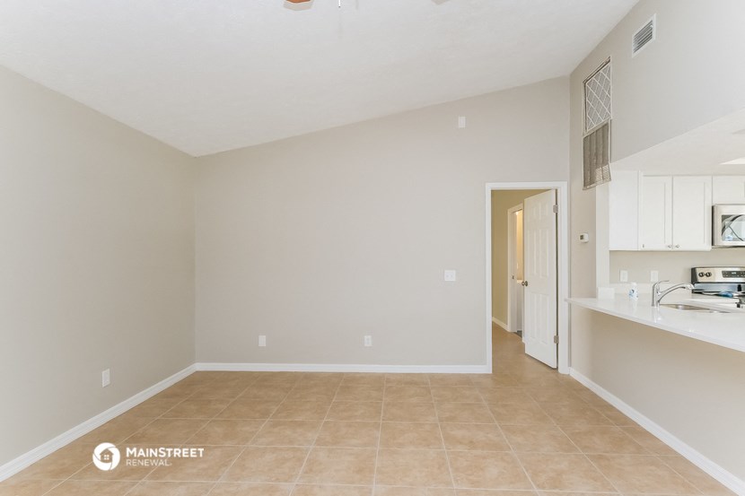 the spacious living room and kitchen of a 560 sq ft home