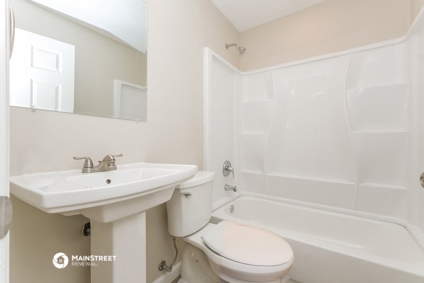 a bathroom with a sink and a toilet and a bath tub