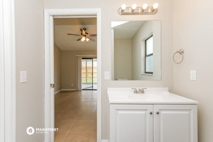 a bathroom with a large mirror and a sink