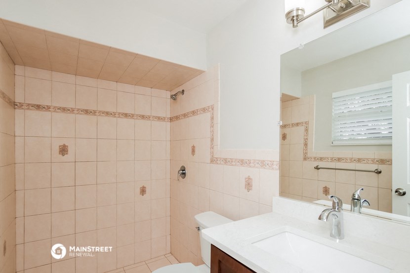 a bathroom with a sink and a toilet and a shower