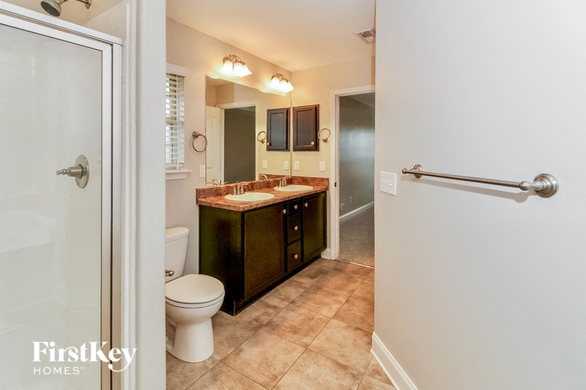 a bathroom with a toilet sink and a mirror