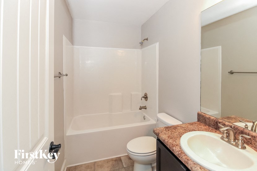 a bathroom with a sink toilet and a bath tub