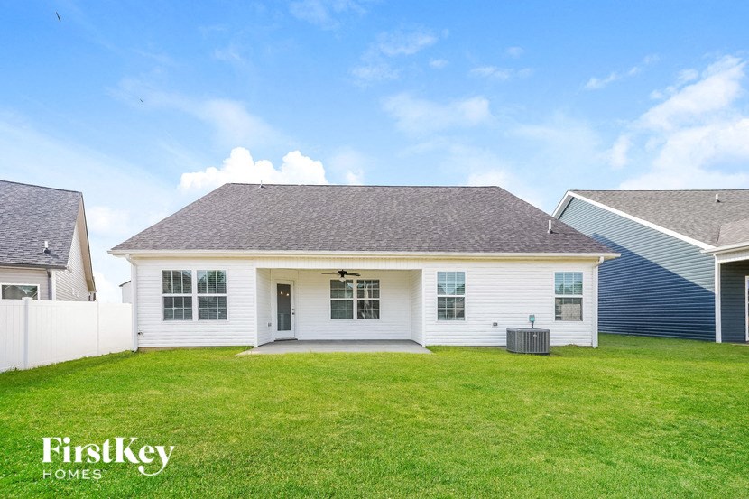 a white house with a green lawn in front of it